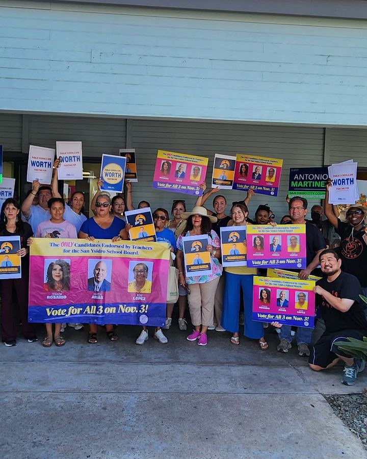 Supporters at the San Ysidro campaign kickoff holding slate signs