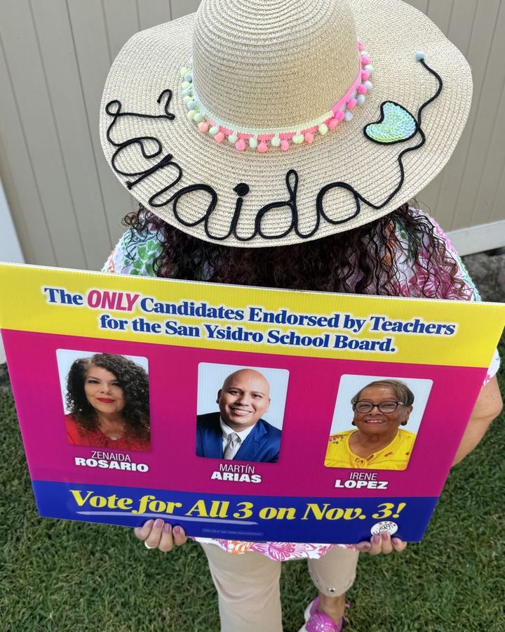 Zenaida Rosario holding the teacher endorsed slate sign