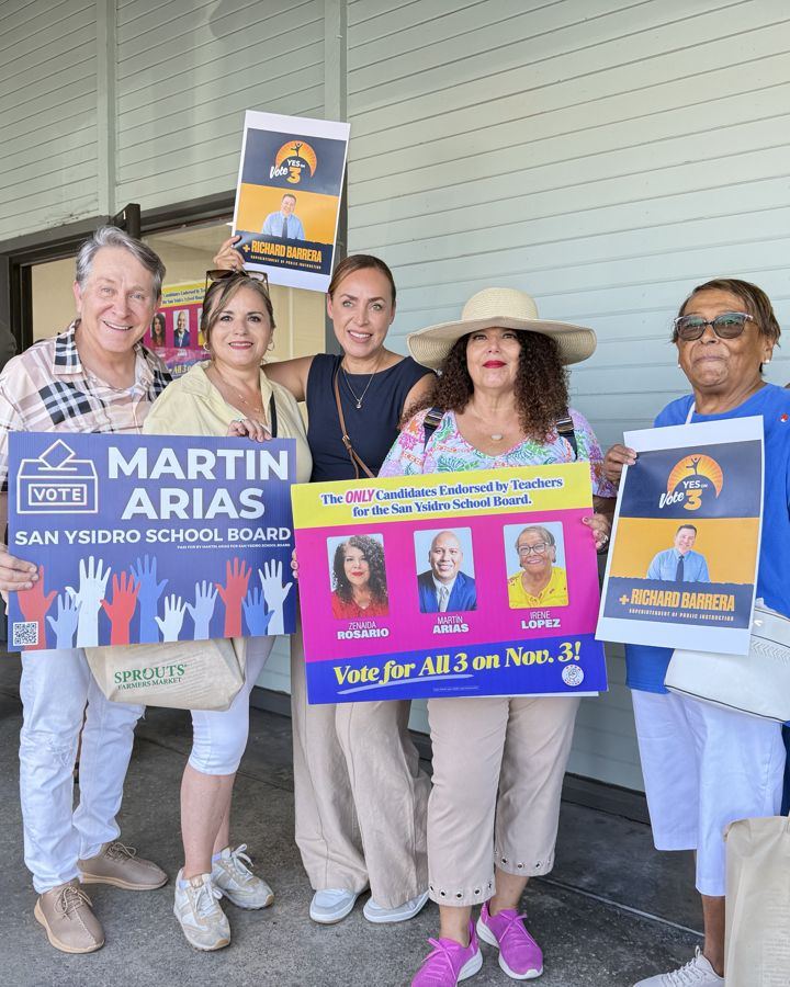 The coalition outside the campaign office with Martin Arias signs